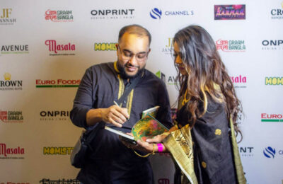Author Ruhul Amin signing copies of his book Amar Shonar Bangla at a community event in London discoverwithruhul