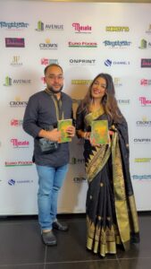 Author Ruhul Amin signing his book Amar Shonar Bangla and posing with Aysha Begum during a Bangladeshi cultural evening in London